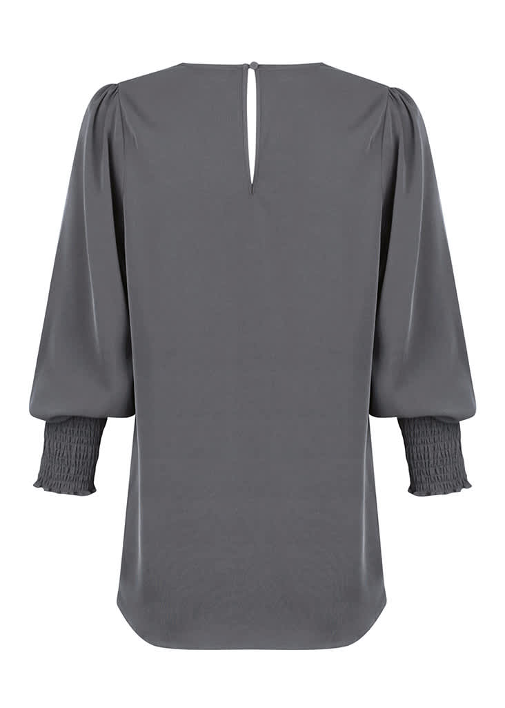 A grey V-neck shirt with long sleeves and smocked details at the cuffs, featuring a keyhole back.