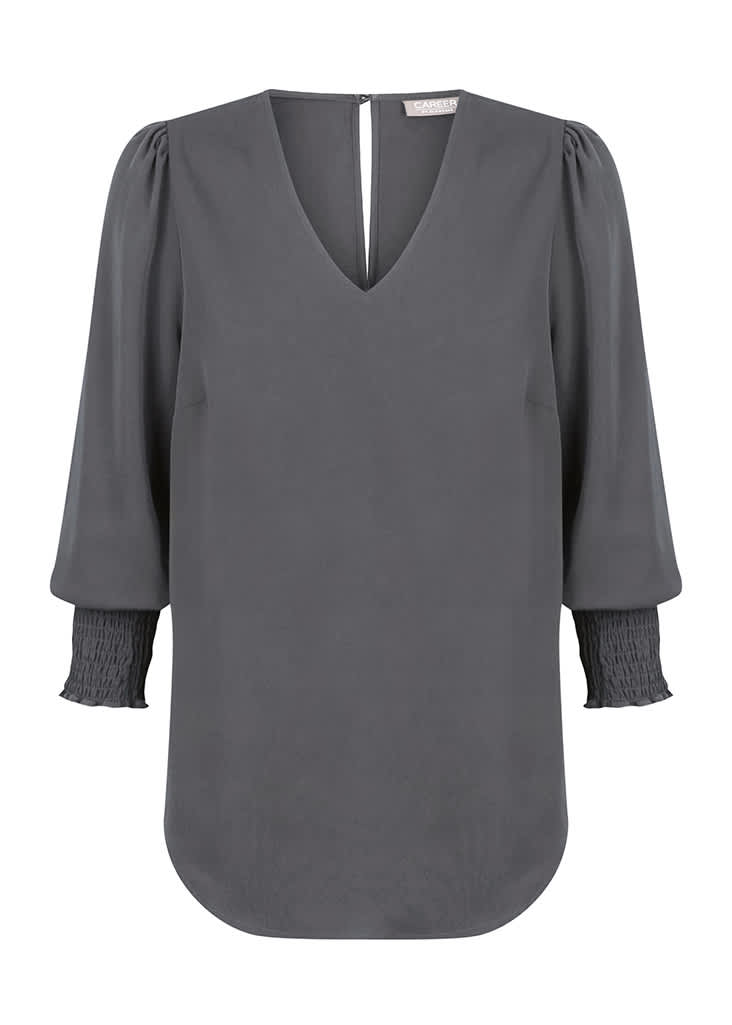 A grey Cleo V Neck shirt featuring a V-shaped neckline and puffed sleeves with smocked cuffs.