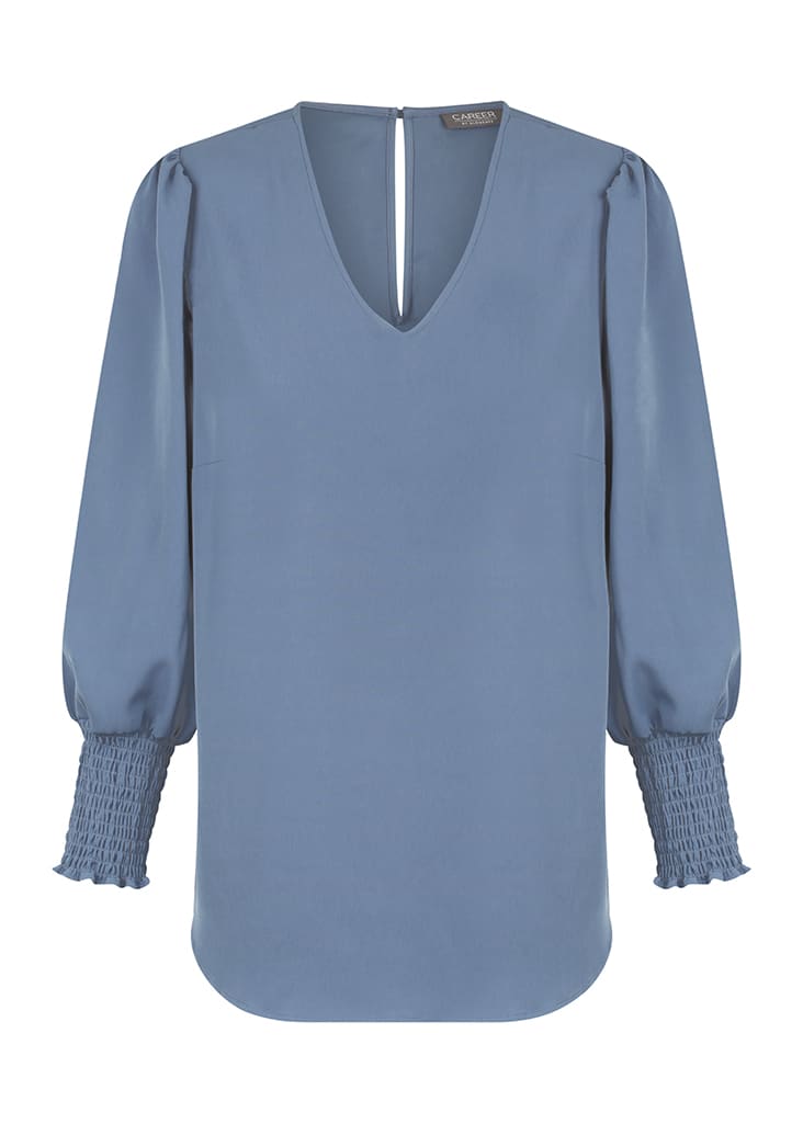 A blue Cleo V Neck shirt with a relaxed fit and textured puff sleeves. The back features a small opening and branding.