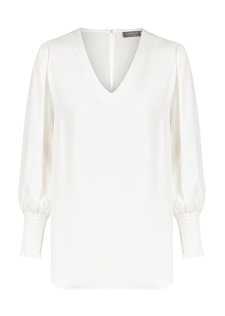 A white V-neck shirt with puffed sleeves and smocked cuffs, featuring a subtle branding label on the back.