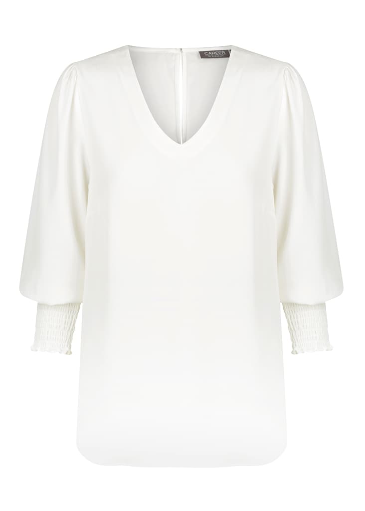A white v-neck shirt with puff sleeves and gathered cuffs, featuring a back zip closure and a logo.
