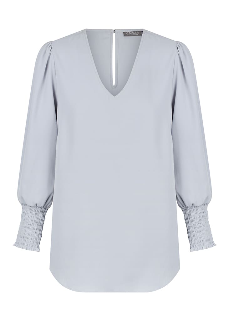 A light blue V-neck shirt with puff sleeves and smocked cuffs, featuring a back keyhole detail.