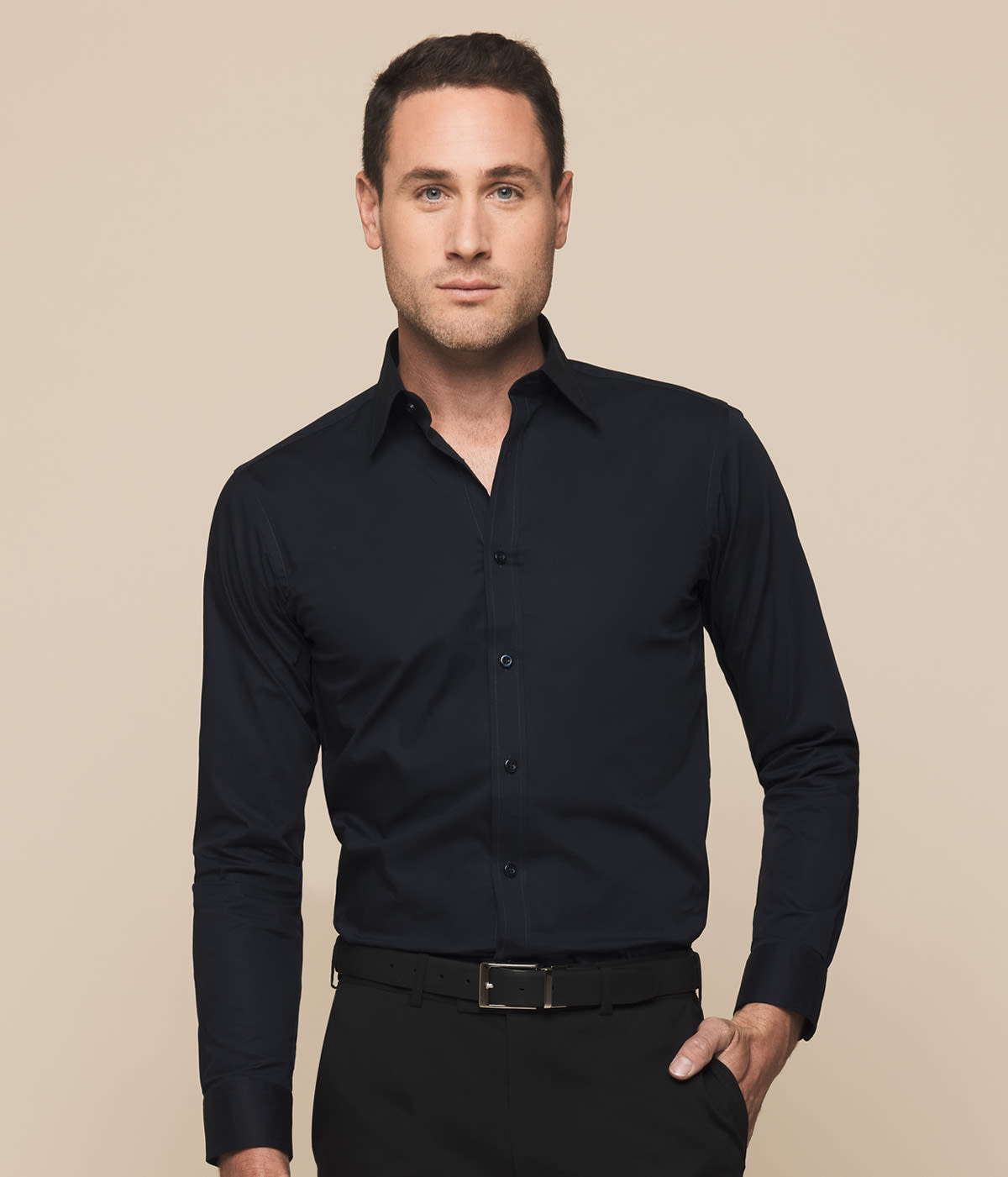 A man wearing a black Olsen Slim Cotton Stretch Shirt with a button-up design and long sleeves.