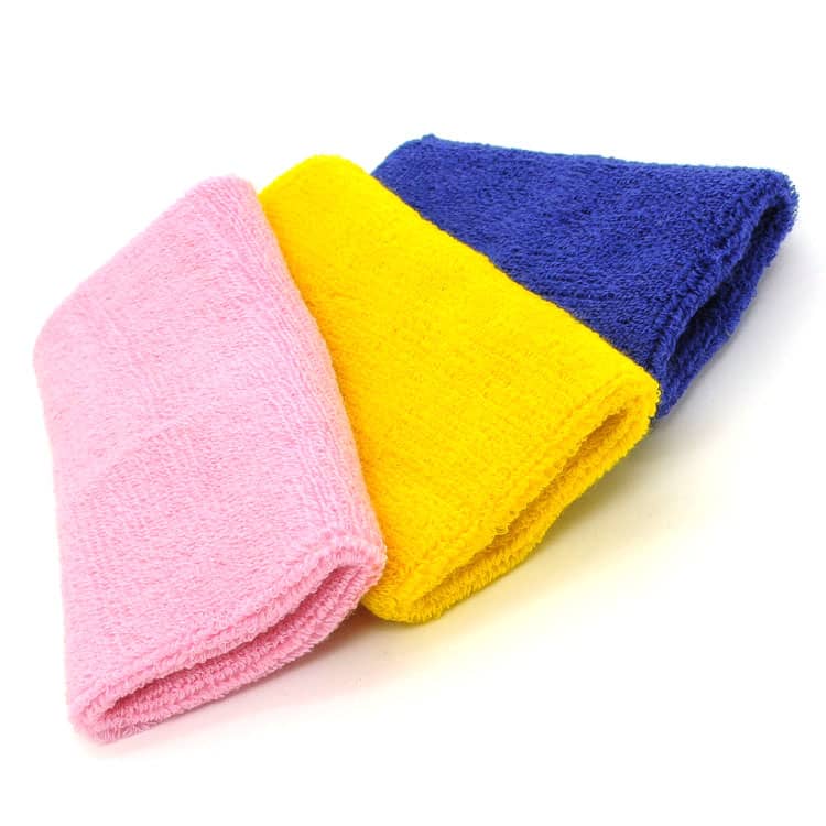 A set of three wristbands in pink, yellow, and blue, featuring a textured fabric. Each wristband has a logo.