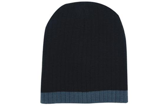 Two Tone Cable Knit Beanie - Toque HE-4195 A two-tone cable knit beanie in dark navy blue with a lighter blue trim. It features a branding logo.