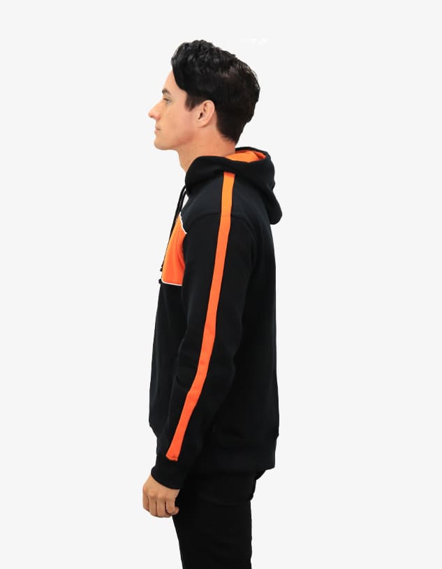 A black hoodie featuring orange stripes, worn by a person seen from the side. The hoodie has a logo.