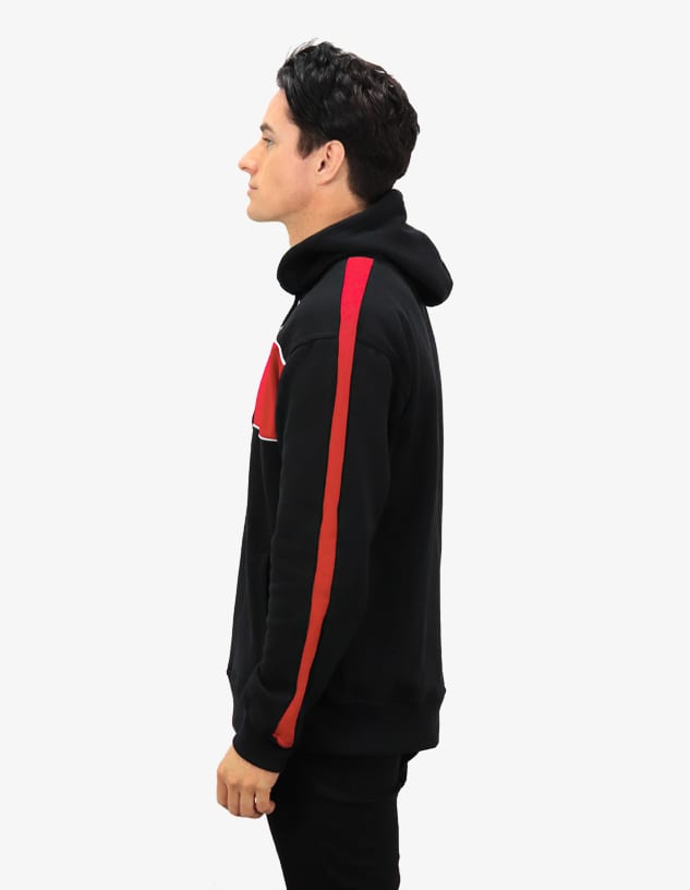 A black hoodie with red side stripes and a logo on the front, displayed on a model from the side.