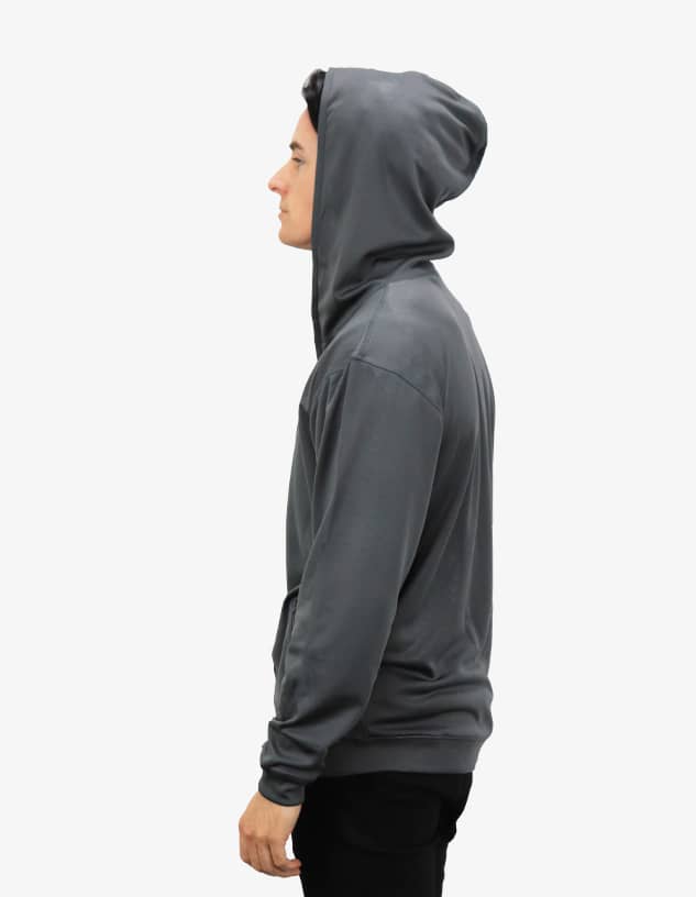A grey hoodie with a drawstring hood, featuring a side view of a model wearing it. The garment has a logo.