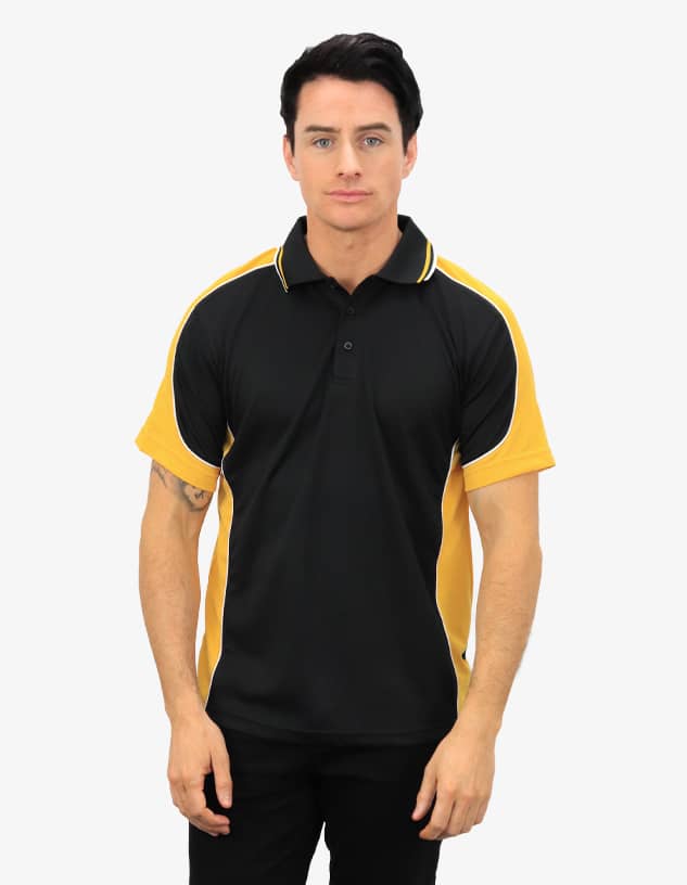 A man stands wearing a black and yellow polo shirt with a logo on the chest. The shirt features contrast piping.