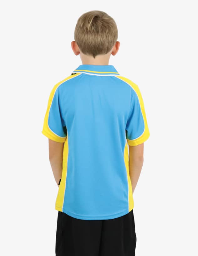 A young boy stands with his back to the camera, wearing a blue and yellow polo shirt. The shirt features a logo on the chest.