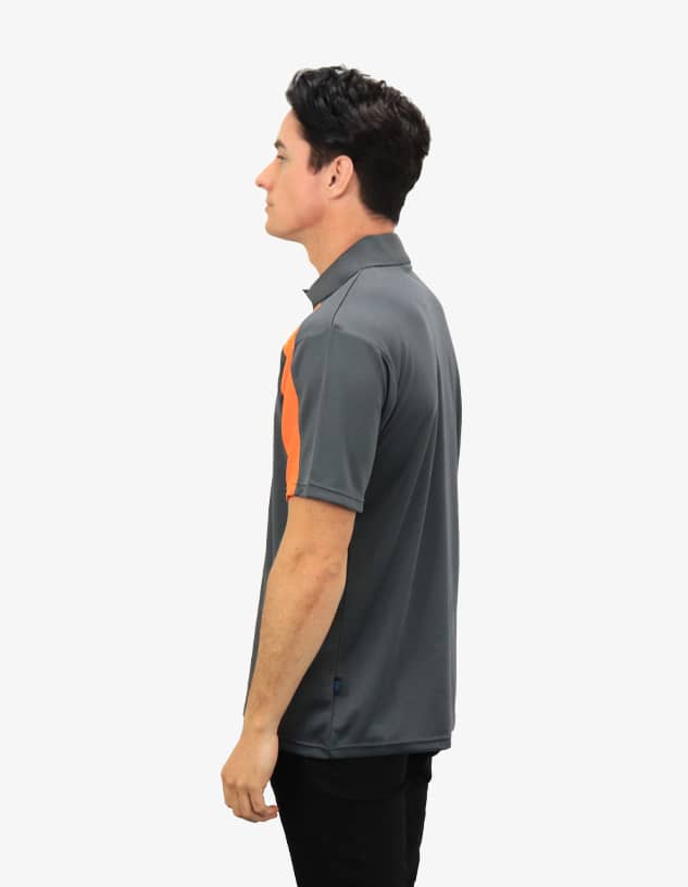 A grey polo shirt featuring orange accents, displayed on a model in profile. Includes a logo on the garment.