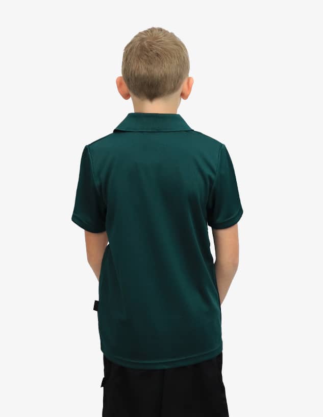 A boy wearing a dark green polo shirt, viewed from the back. The shirt features a logo on the collar.