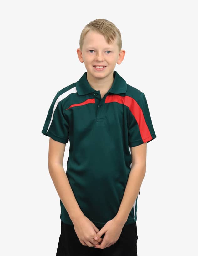 A boy wearing a dark green polo shirt with red and white accents, featuring a logo on the chest.