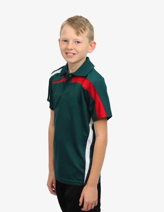 A young boy in a green polo shirt with red and white accents, featuring a logo on the chest.