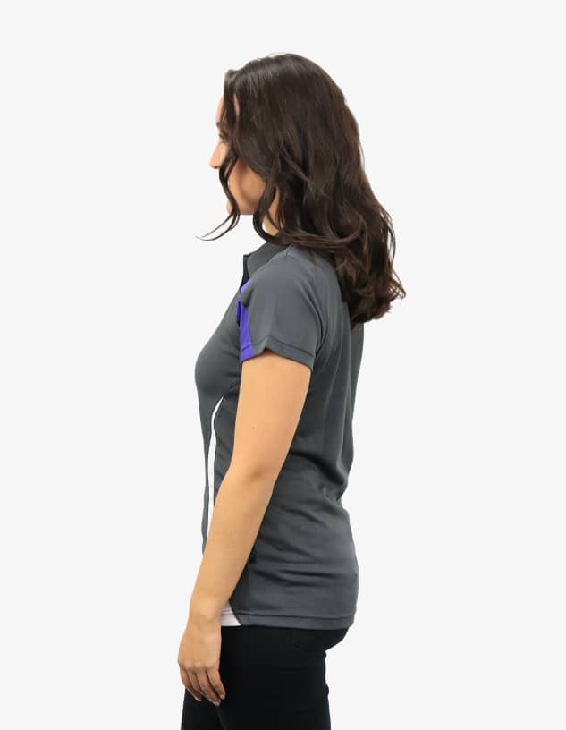 A grey polo shirt with purple accents, featuring a side profile view of a woman wearing it. The shirt has a branding logo.