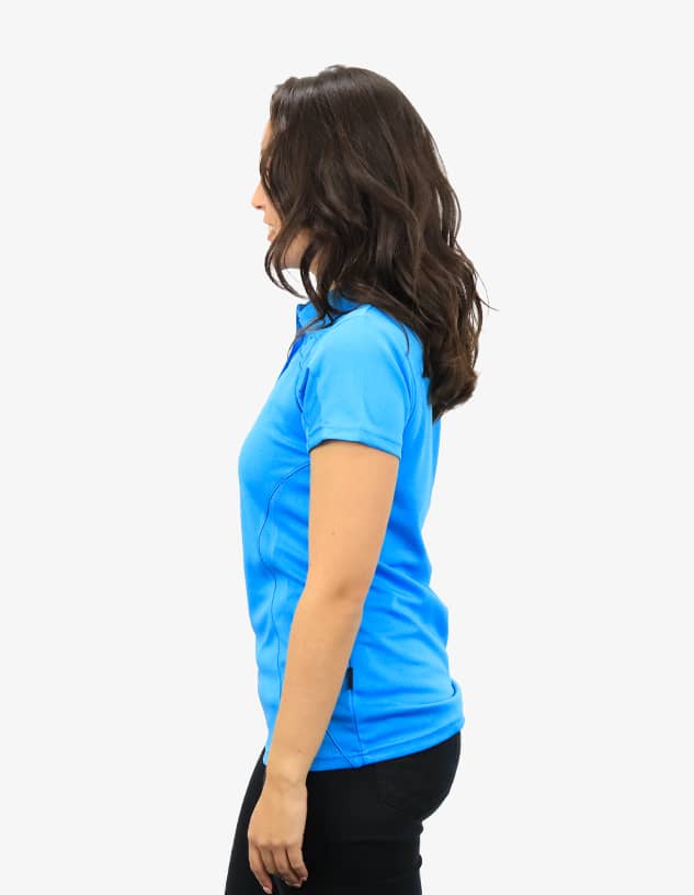 A side view of a blue polo shirt worn by a woman, featuring a logo on the chest.