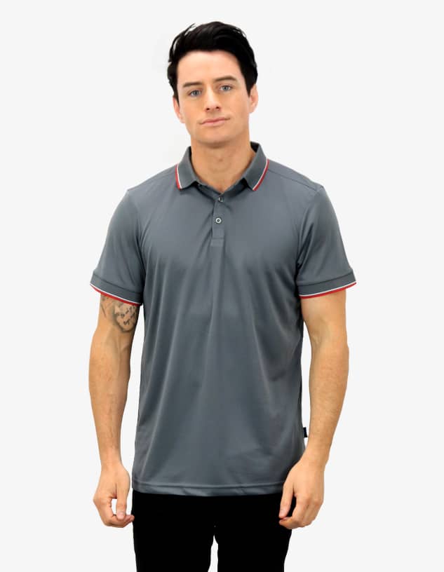 A grey polo shirt with red accents, featuring a collar and short sleeves, modelled by a person.