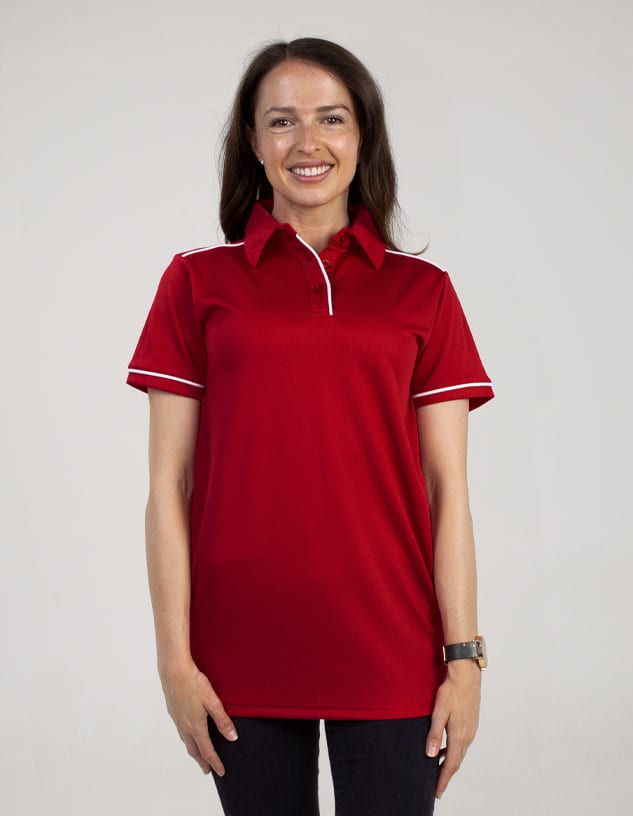 A red polo shirt is displayed on a woman, featuring a collar and a logo. The shirt has white detailing.