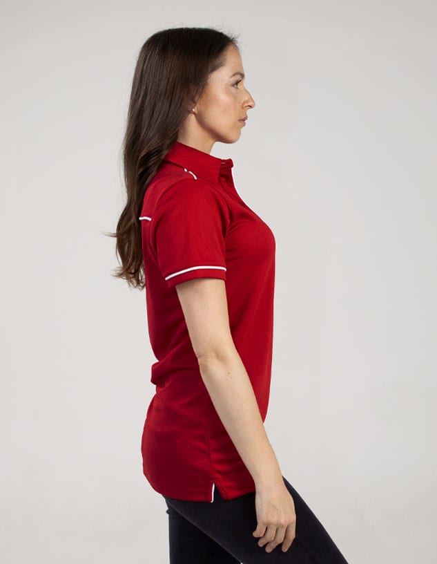 A red polo shirt with white trim, displayed on a model from the side. The shirt features a logo.