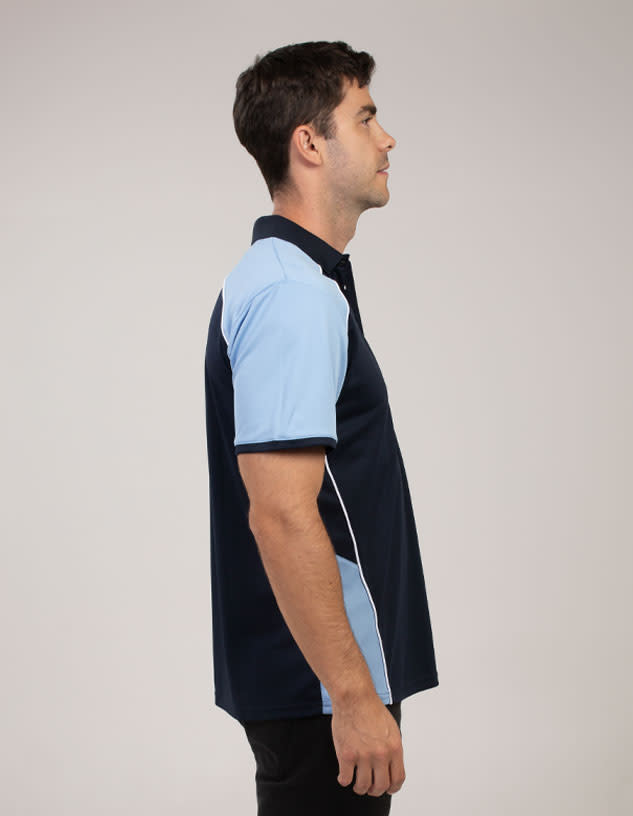 A navy and light blue polo shirt featuring a logo, displayed on a model from the side.