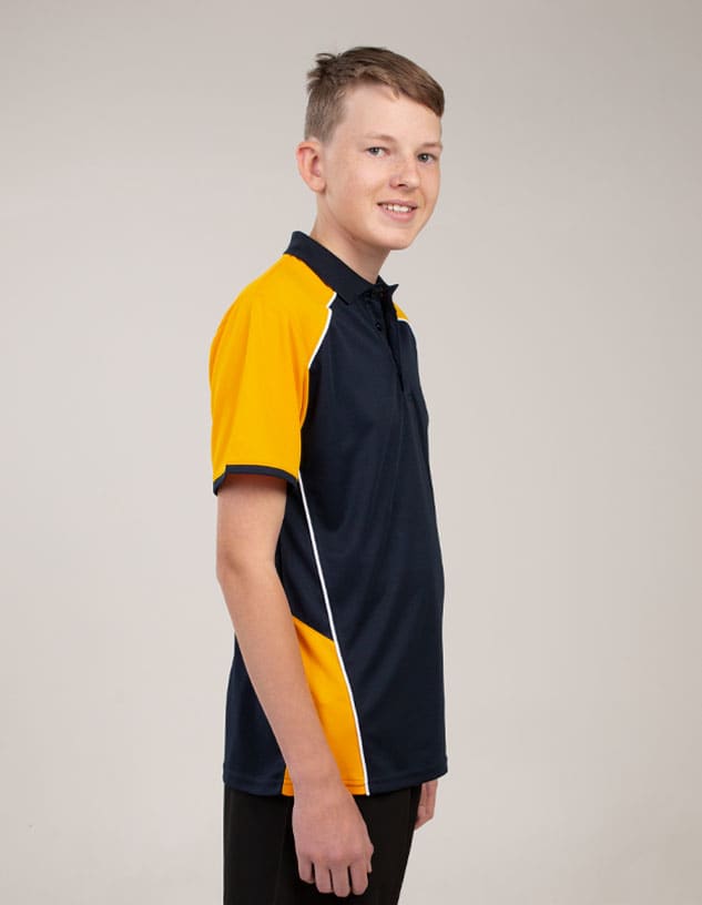 A polo shirt in navy blue and bright yellow with a branding logo, displayed on a young model.