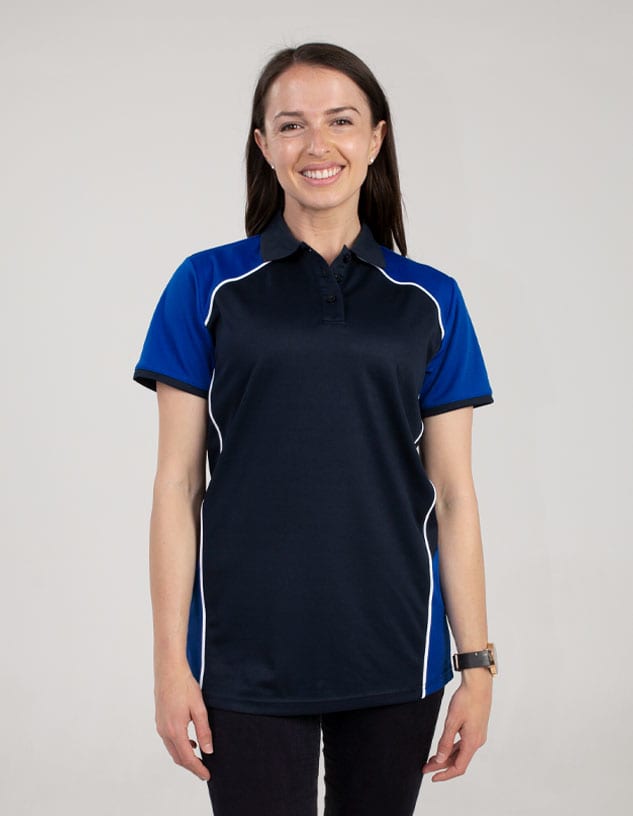 A navy blue polo shirt with blue sleeves and white accents, displayed on a smiling woman. It features a branding logo.