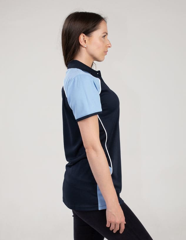 A navy and light blue polo shirt featuring a logo, displayed on a model from the side.