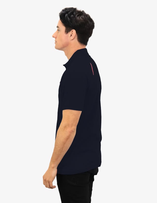 A navy polo shirt displayed on a model from the side, featuring a logo on the chest and a contrasting detail on the back.
