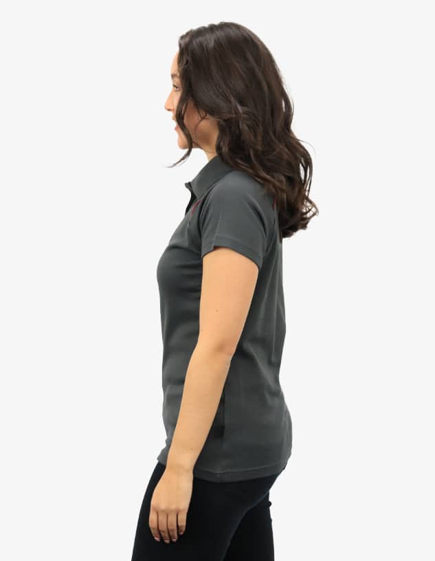 A polo shirt in dark grey, featuring a subtle logo, displayed on a model from the side.