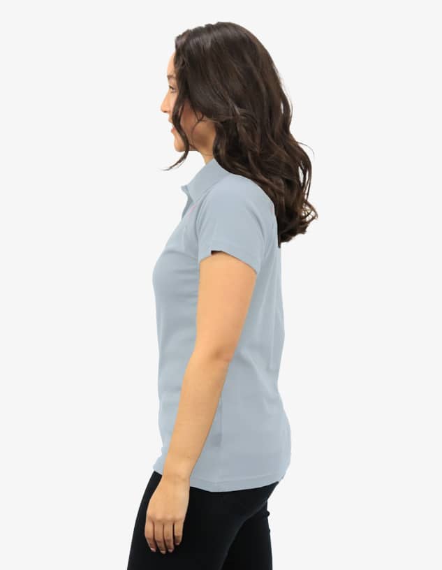Polo shirt in light blue, displayed on a model from the side, featuring a logo on the chest.