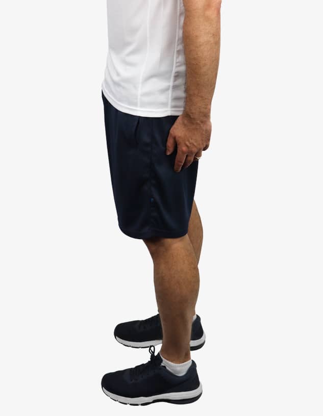 Navy sports shorts displayed on a model, featuring a loose fit and sleek design. The model is wearing athletic shoes.