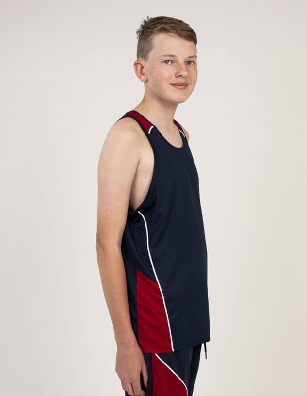 A young person wearing a navy blue and red singlet with contrasting white detailing and a logo.