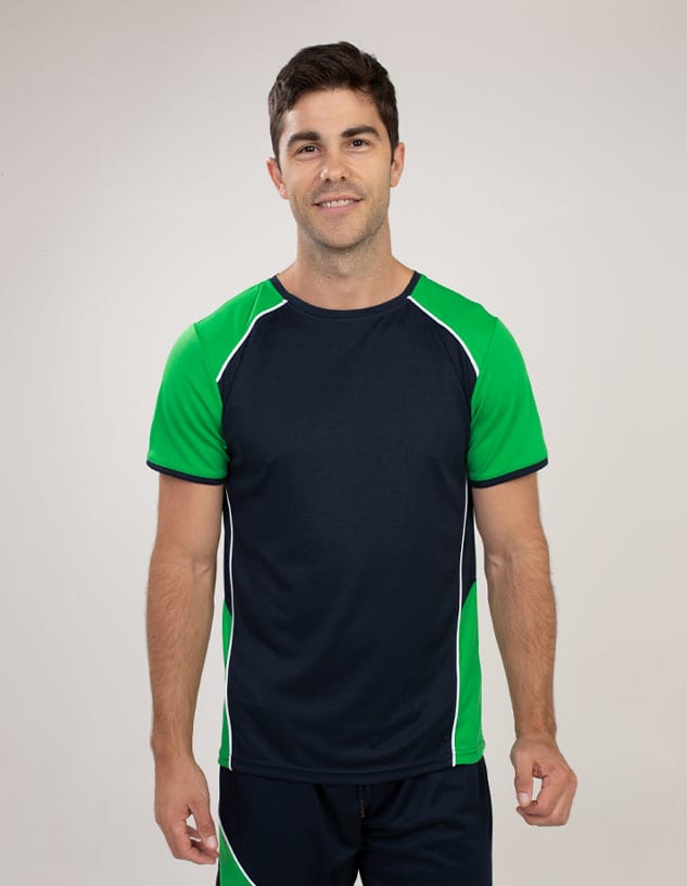 A man wears a navy blue and green t-shirt with a logo, featuring a sporty design and short sleeves.