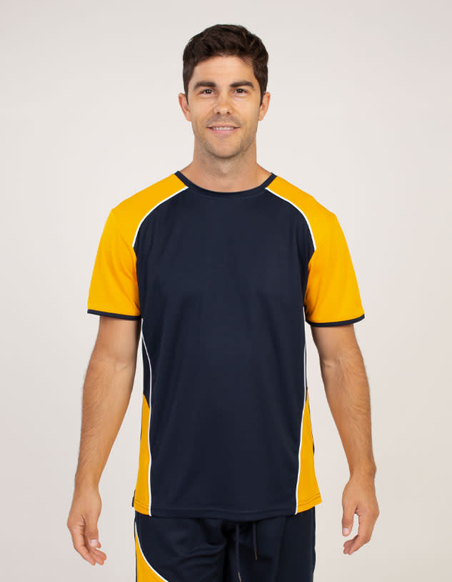 A man wearing a navy and orange short-sleeve T-shirt with contrasting design elements and a logo.