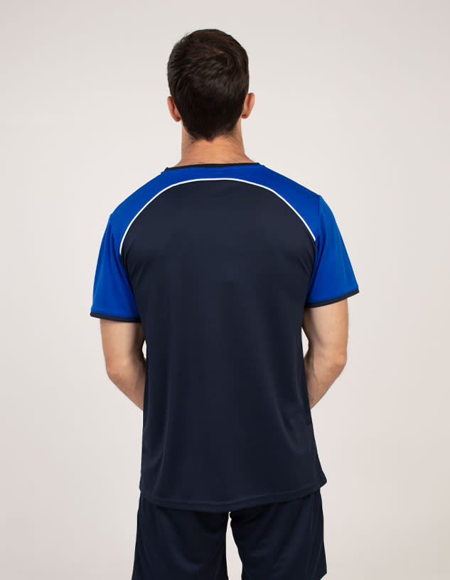 A man is wearing a navy blue and blue T-shirt with a sporty design and a logo on the back.