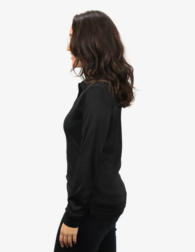 A black polo shirt is displayed on a model from the side, showcasing its sleek fit and design.