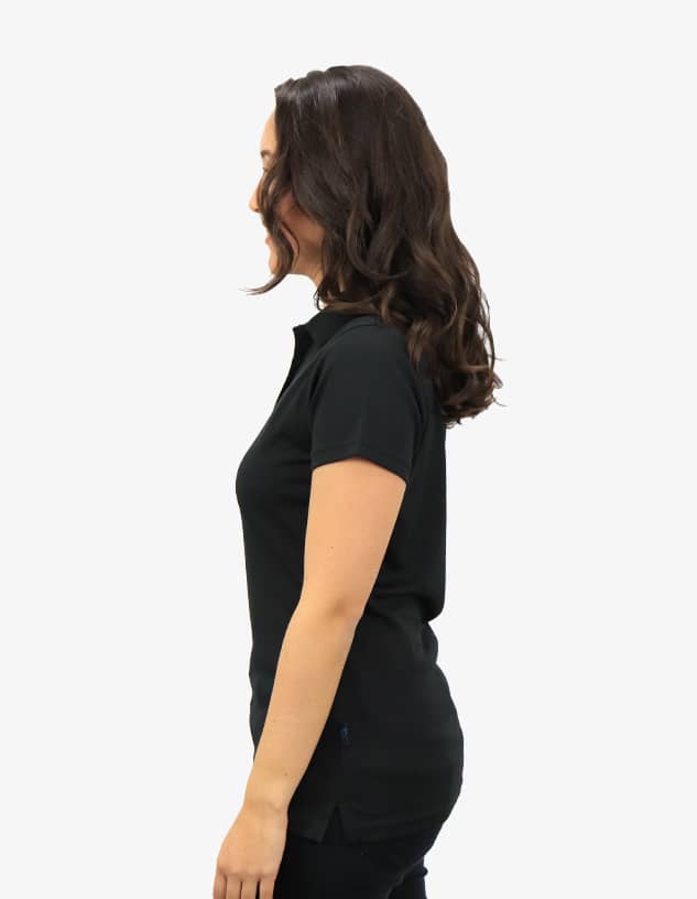 A black polo shirt displayed on a model from the side, featuring a subtle logo on the garment.