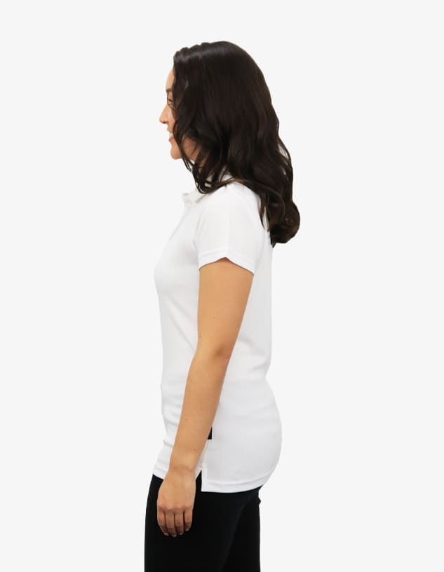 A white polo shirt displayed on a model from the side, featuring a fitted silhouette and a logo.