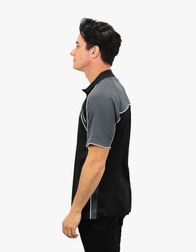 A black and grey polo shirt with a logo, displayed on a model from the side.