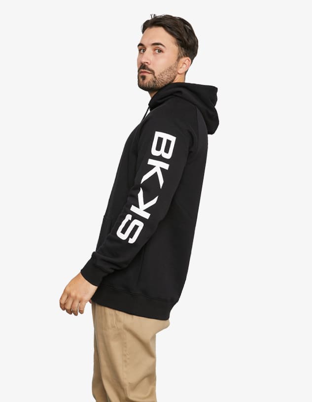 A black hoodie featuring a logo on the sleeve and a relaxed fit, suitable for casual wear.