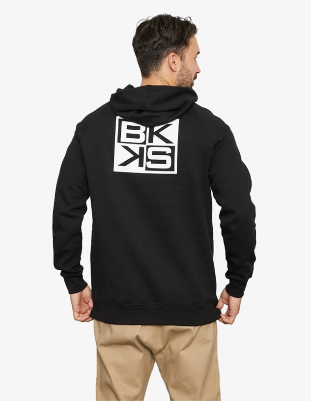A black hooded jumper featuring a logo on the back and a relaxed fit. The model is turned away from the camera.