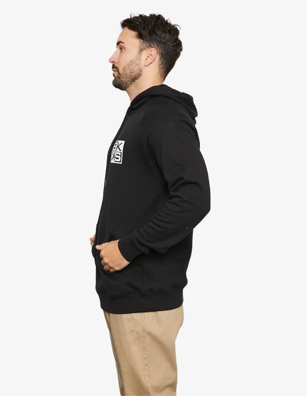 A black hoodie featuring a logo, shown on a model from the side.