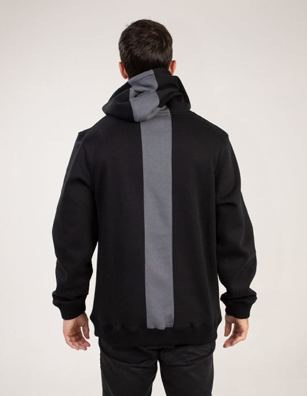 A black hoodie with a grey panel design at the back. It features a hood and a modern cut.