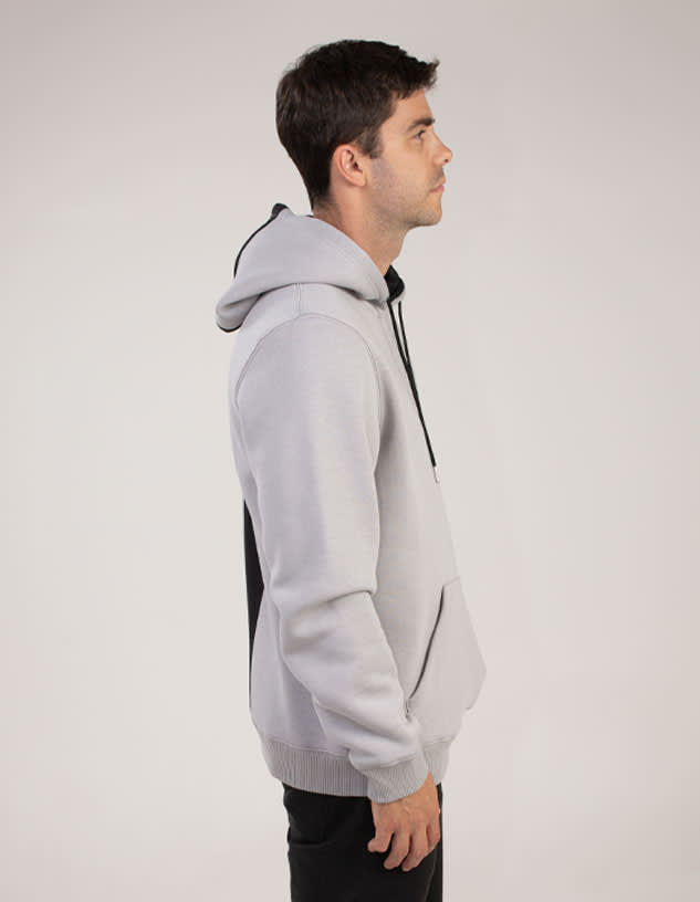 A grey hoodie with a contrasting black panel and a drawstring hood, featuring a front pocket and a logo.