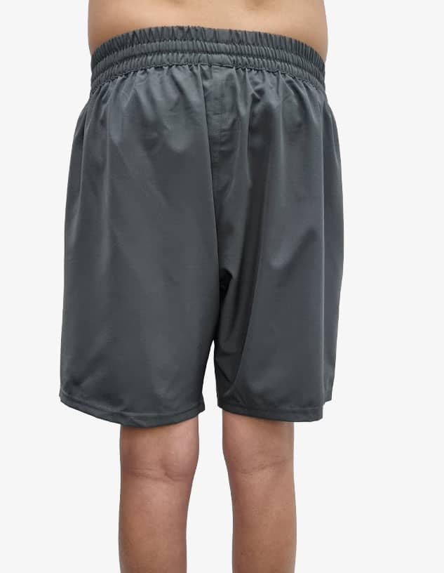 Sporty grey shorts featuring an elastic waistband and a brand logo. Ideal for activewear or casual outings.