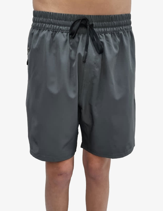 Sports shorts in dark grey with an elastic waistband and drawstring. Features a logo on the side.