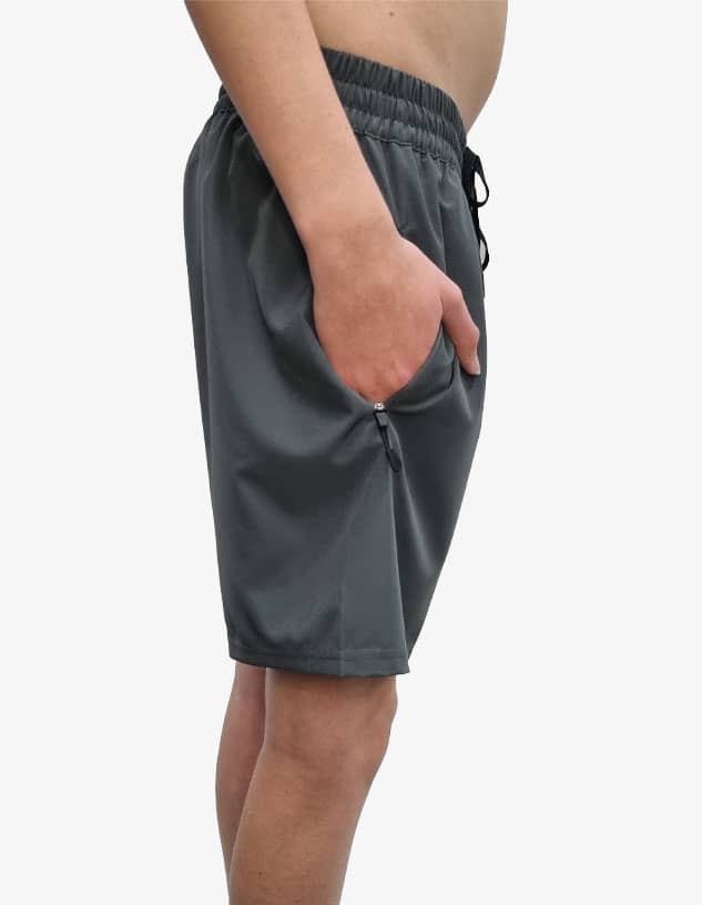 Sports shorts in a dark grey colour, featuring an elastic waistband and side pockets, with a logo present.
