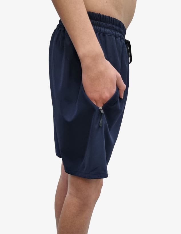 Navy sports shorts featuring a drawstring waist and side pockets. The model is shown from the side.
