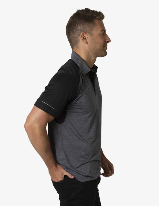 A grey and black polo shirt is displayed on a model, featuring a logo on the chest and short sleeves.