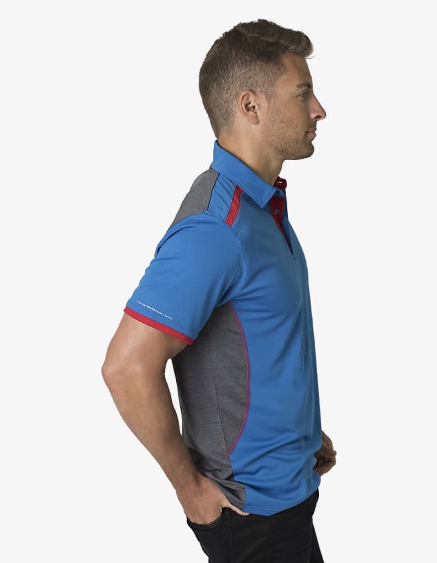 A blue and grey polo shirt featuring a logo, worn by a model in profile.